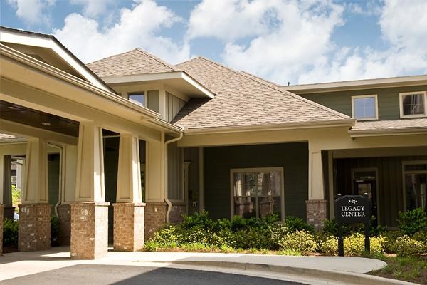 a large house with a sign in front of it
