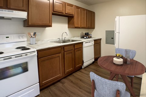a kitchen with white appliances and a wooden table with chairs