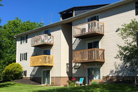 the back of a white house with two balconies at Oakwood Apartments, Florence, KY