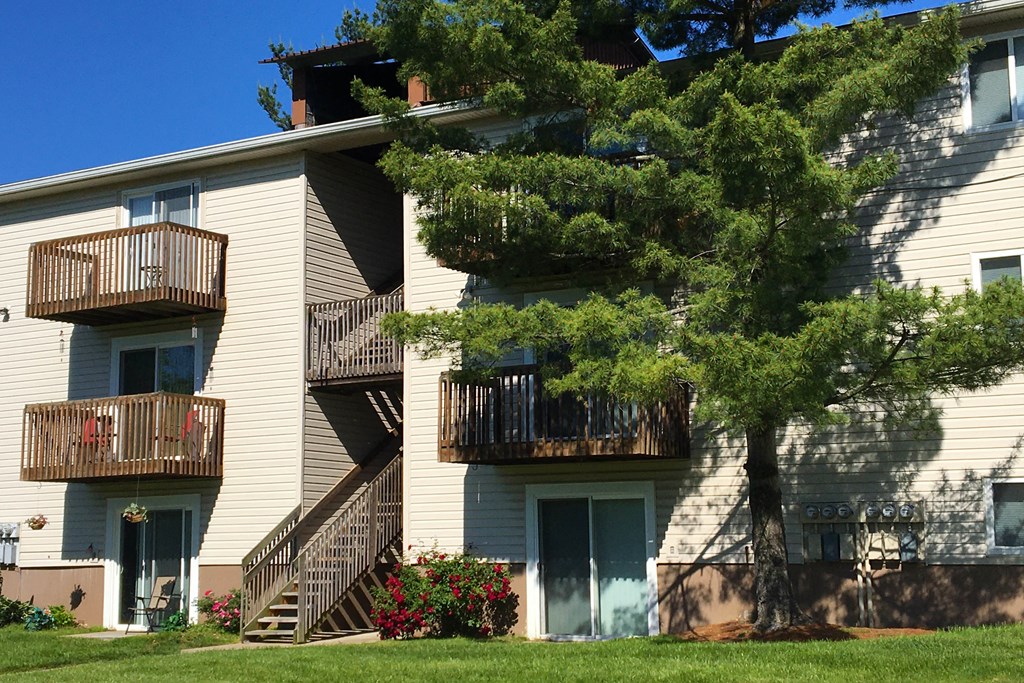 the balconies of an apartment building with stairs and trees at Oakwood Apartments, Florence, 41042