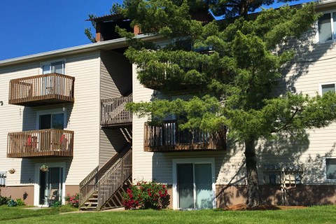 the balconies of an apartment building with stairs and trees at Oakwood Apartments, Florence, 41042