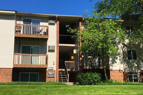 a view of an apartment building with stairs and a tree at Oakwood Apartments, Florence, Kentucky