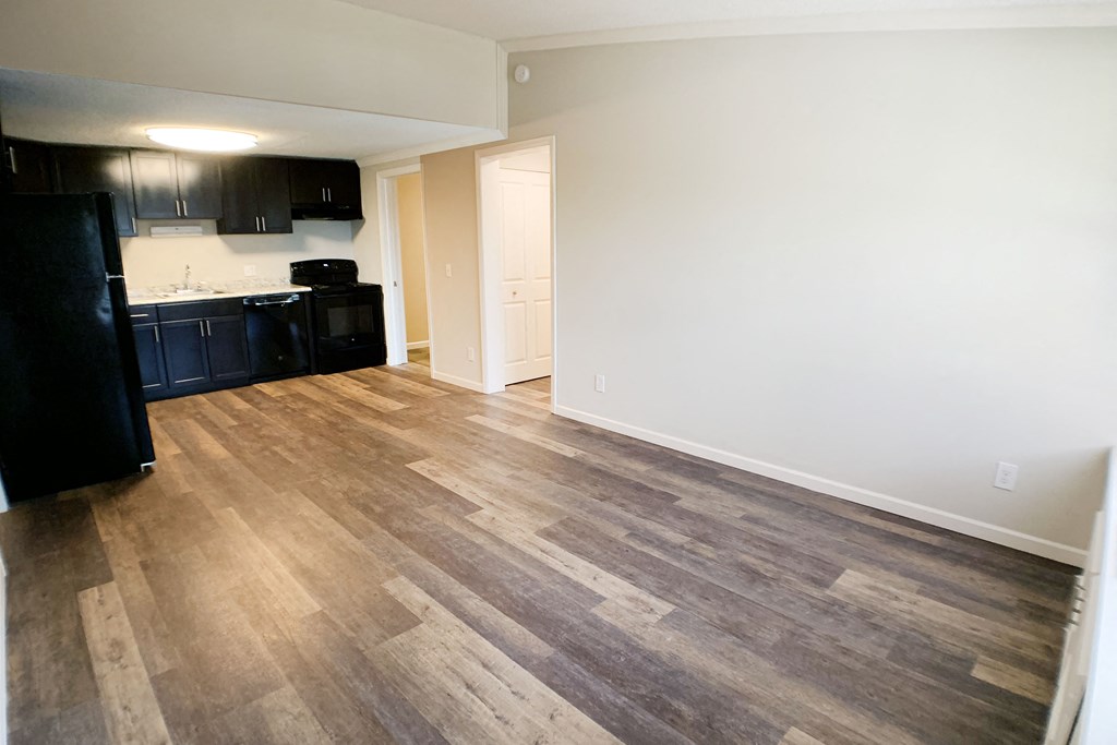 an empty kitchen and living room with wood flooring in an apartment at Wentworth Estates Apartments, Florence, KY