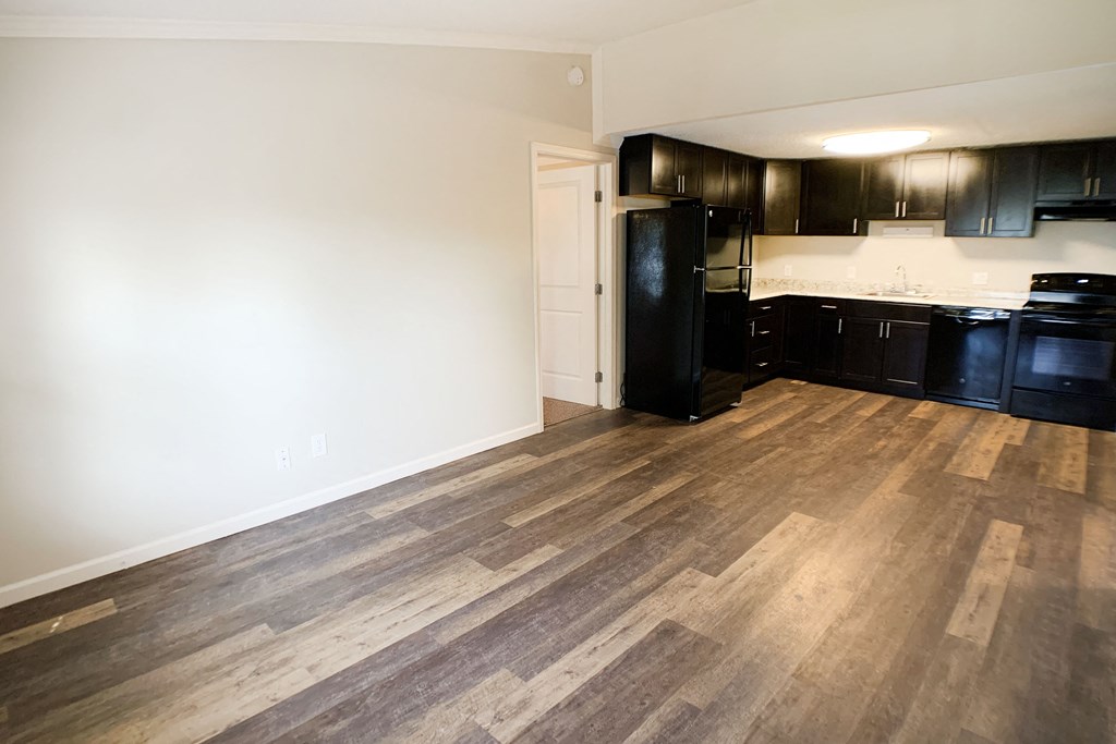 a kitchen and living room with black appliances and wood flooring at Wentworth Estates Apartments, Florence, KY