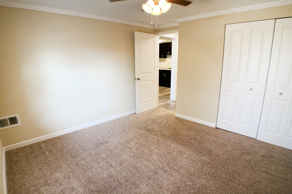 an empty living room with carpet and white doors at Wentworth Estates Apartments, Florence, 41042