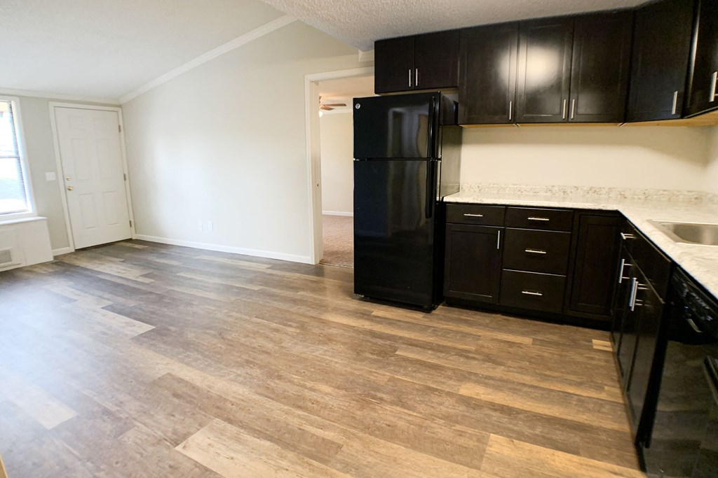 an empty kitchen with black appliances and wooden floors at Wentworth Estates Apartments, Florence, 41042