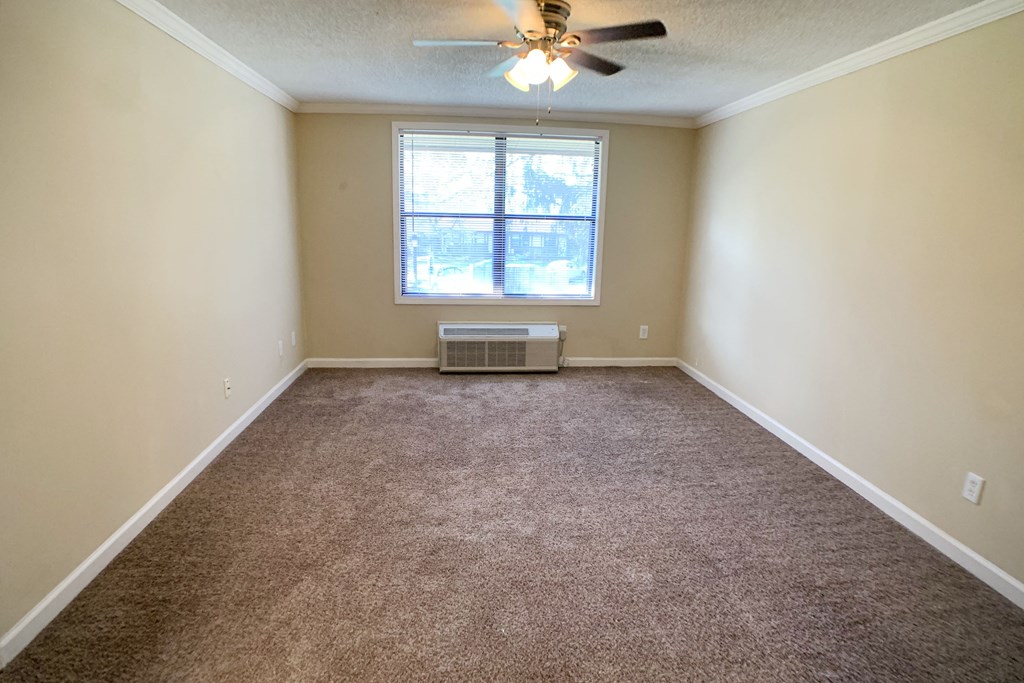 an empty living room with a ceiling fan and a window at Wentworth Estates Apartments, Florence, 41042