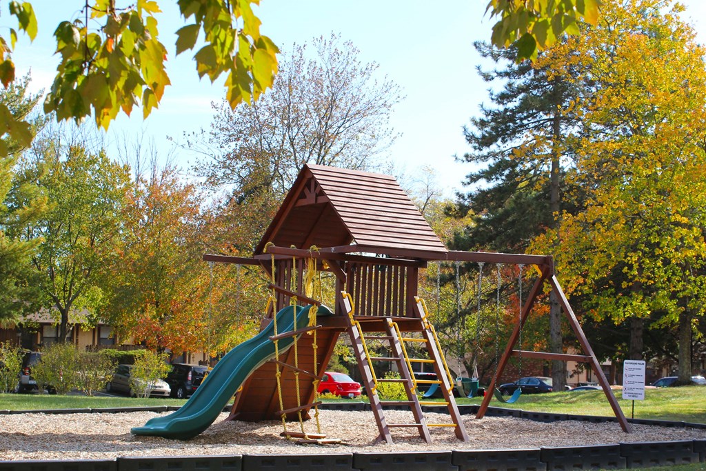 a playground with a swing set and a slide  at Wentworth Estates Apartments, Kentucky