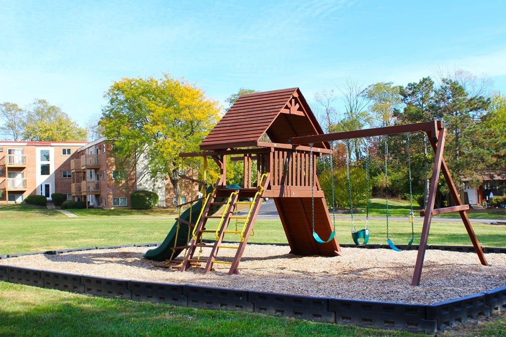 a playground with a swing set in a park  at Wentworth Estates Apartments, Kentucky