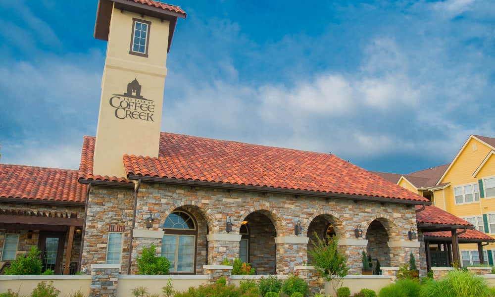the facade of the coffee creek building with a sign on the side of it
