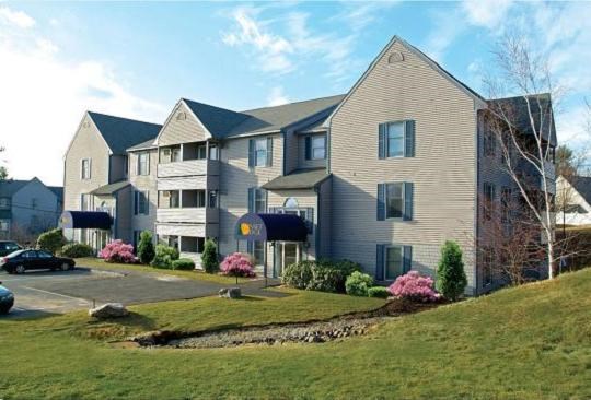 a large apartment building on top of a hill