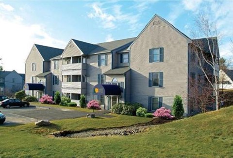 a large apartment building on top of a hill