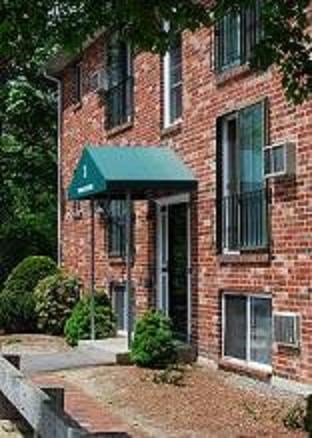 a brick building with a green awning on the front