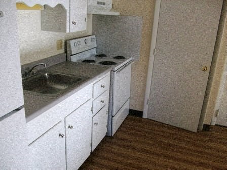 a kitchen with a sink and a stove in it