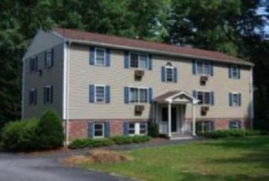 a large yellow house with blue shutters and a driveway