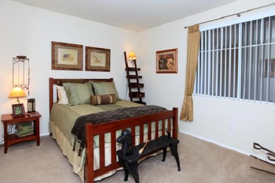 a bedroom with a bed and a large window