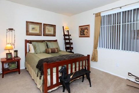 a bedroom with a bed and a large window