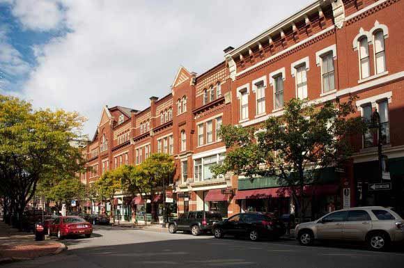 a city street with cars parked on the side of the road