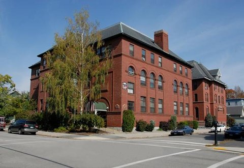a red brick building on the side of a street