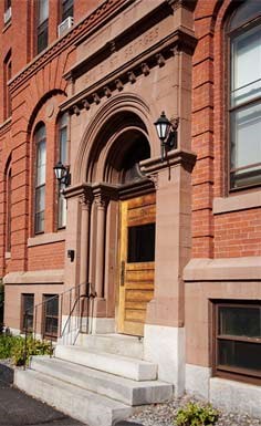a red brick building with a wooden door and stairs