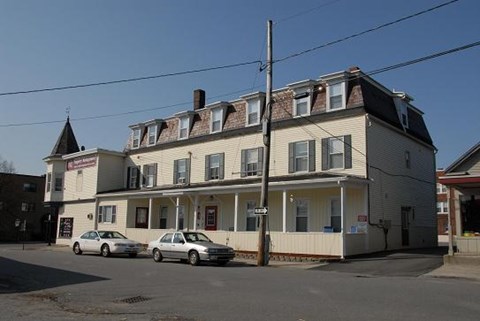 a large white house on the corner of a street