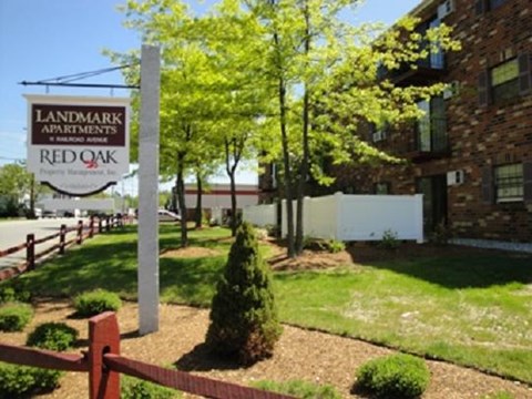 a yard with a sign in front of a building