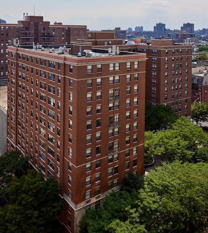 an aerial view of a tall brick building in a city