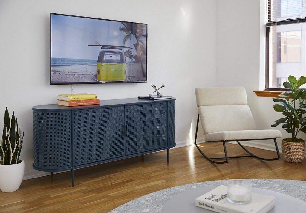a living room with a cabinet and a tv on the wall
