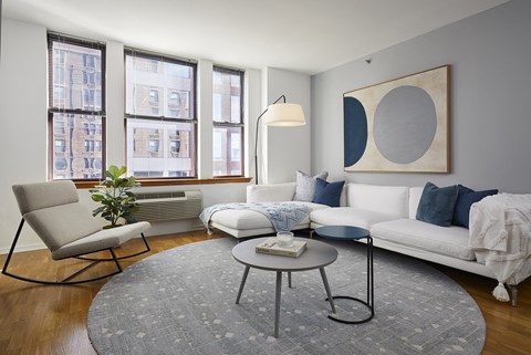 a living room with a white couch and a round table