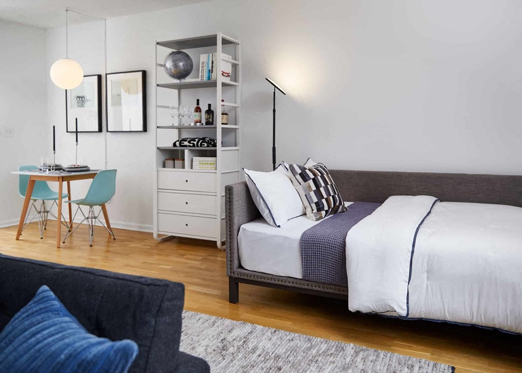 a bedroom with a bed and a desk and a chair