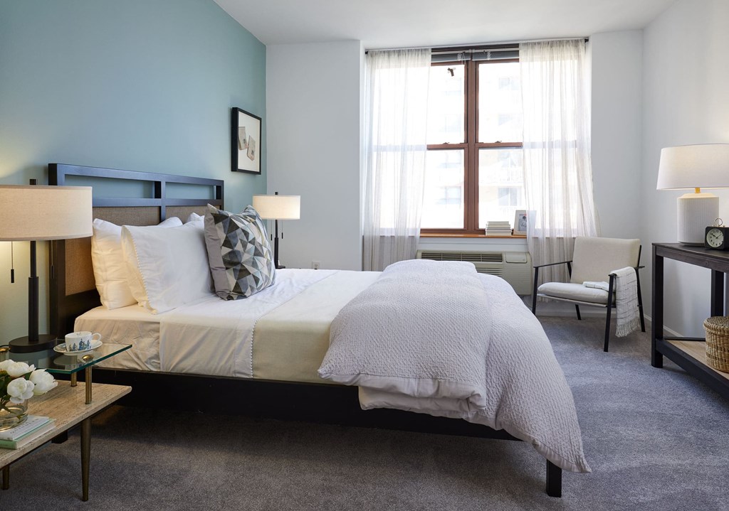 a bedroom with a bed and a window