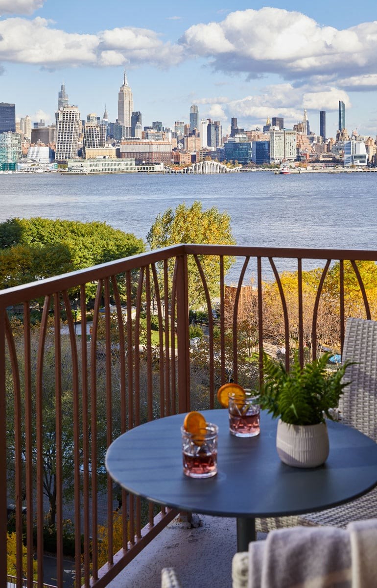 a view of the skyline from a balcony with a table