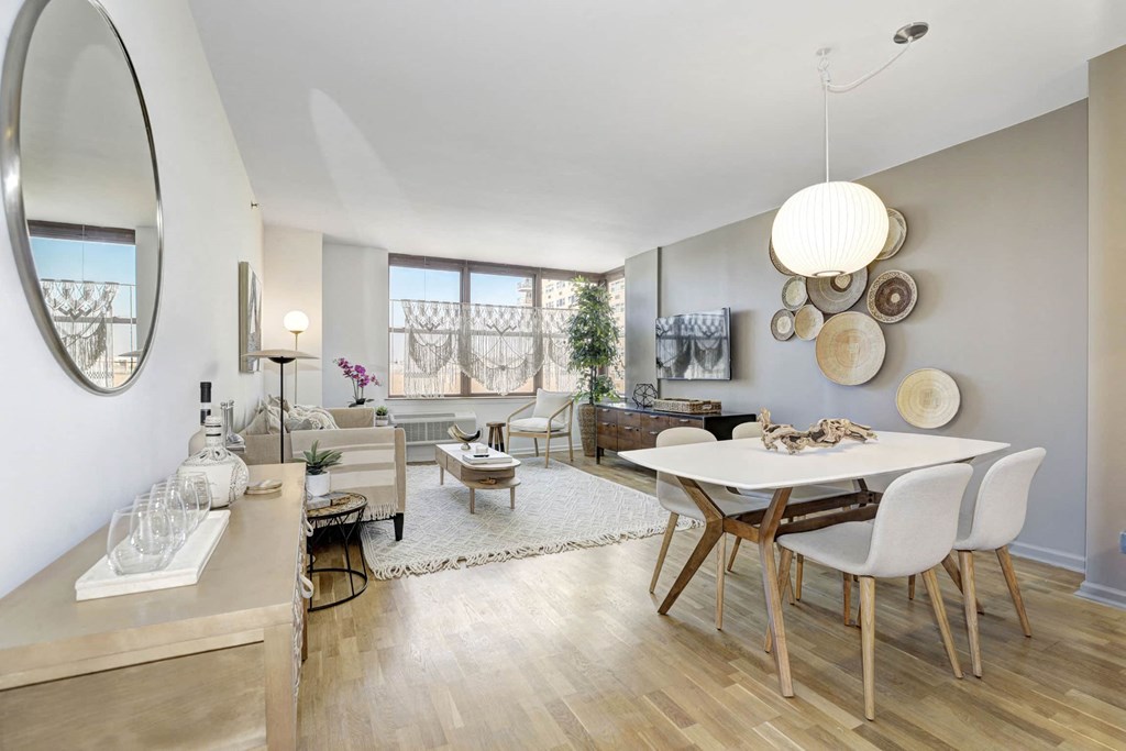 a dining room and living room with a table and chairs