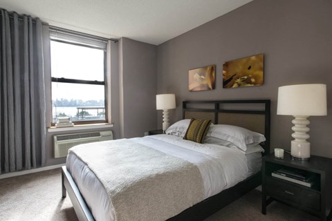 a bedroom with a large bed and a window
