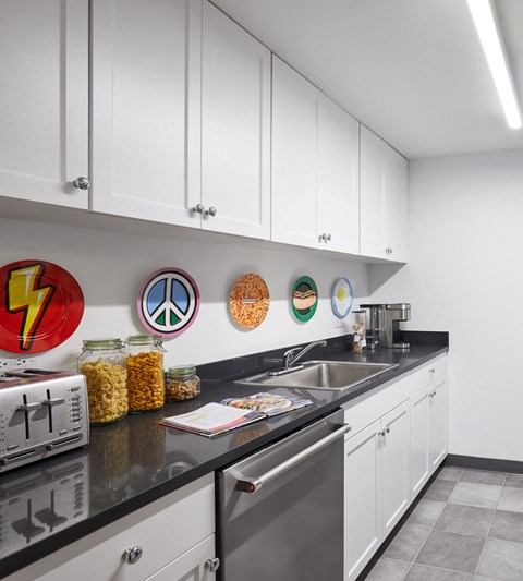 a kitchen with white cabinets and a sink