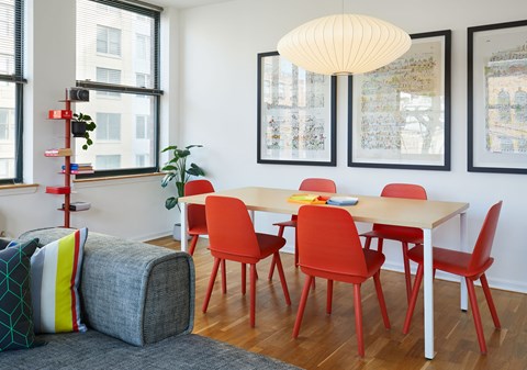 a dining room with a table and chairs and a couch