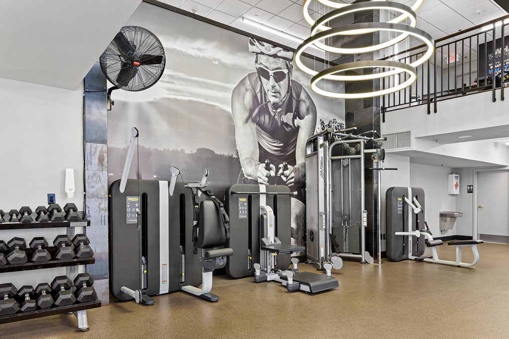 a wall mural of a man working out with weights in a gym