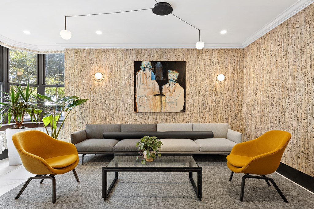 a living room with a couch and chairs and a table