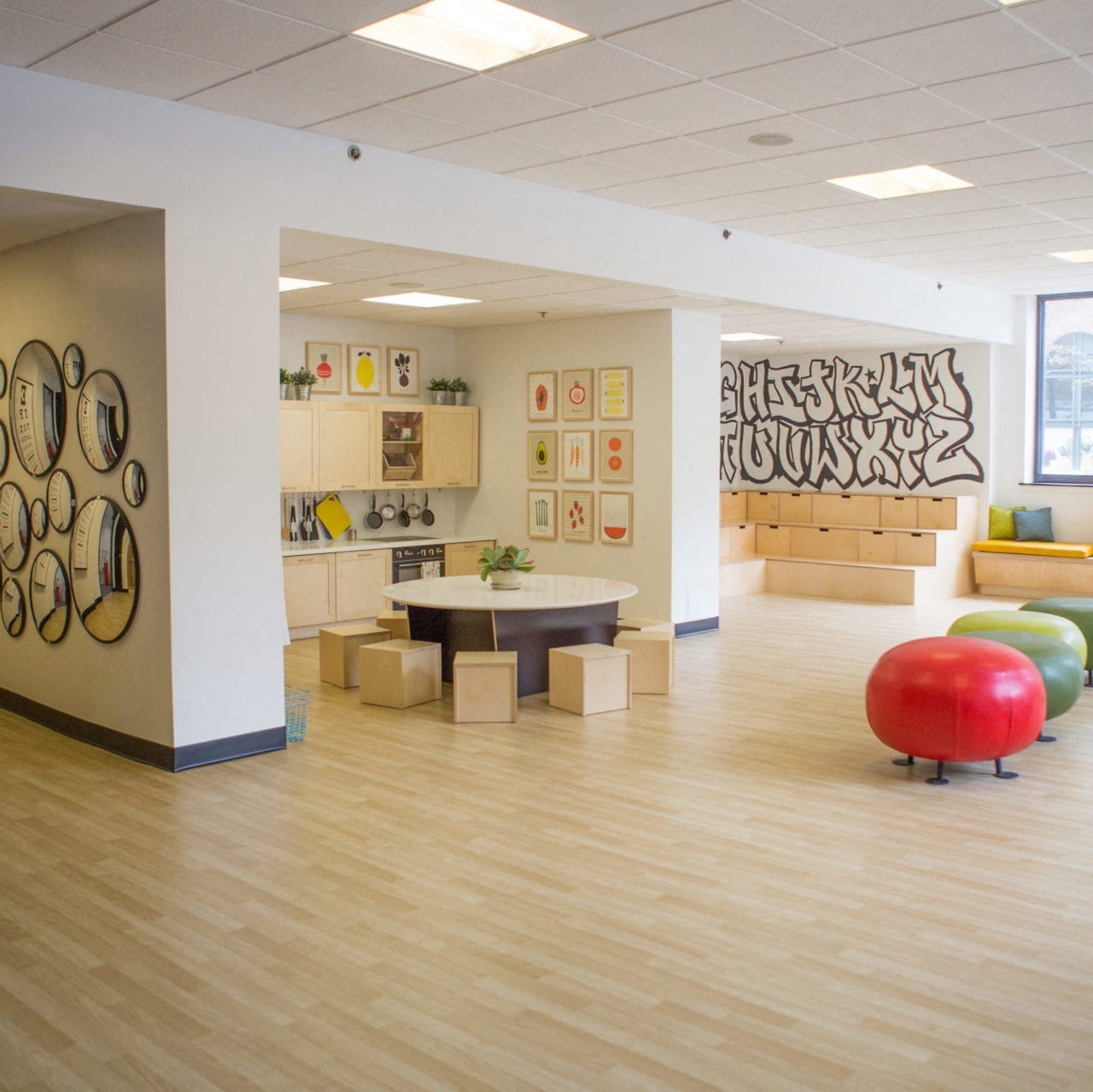 a waiting room at a hospital with a table and chairs
