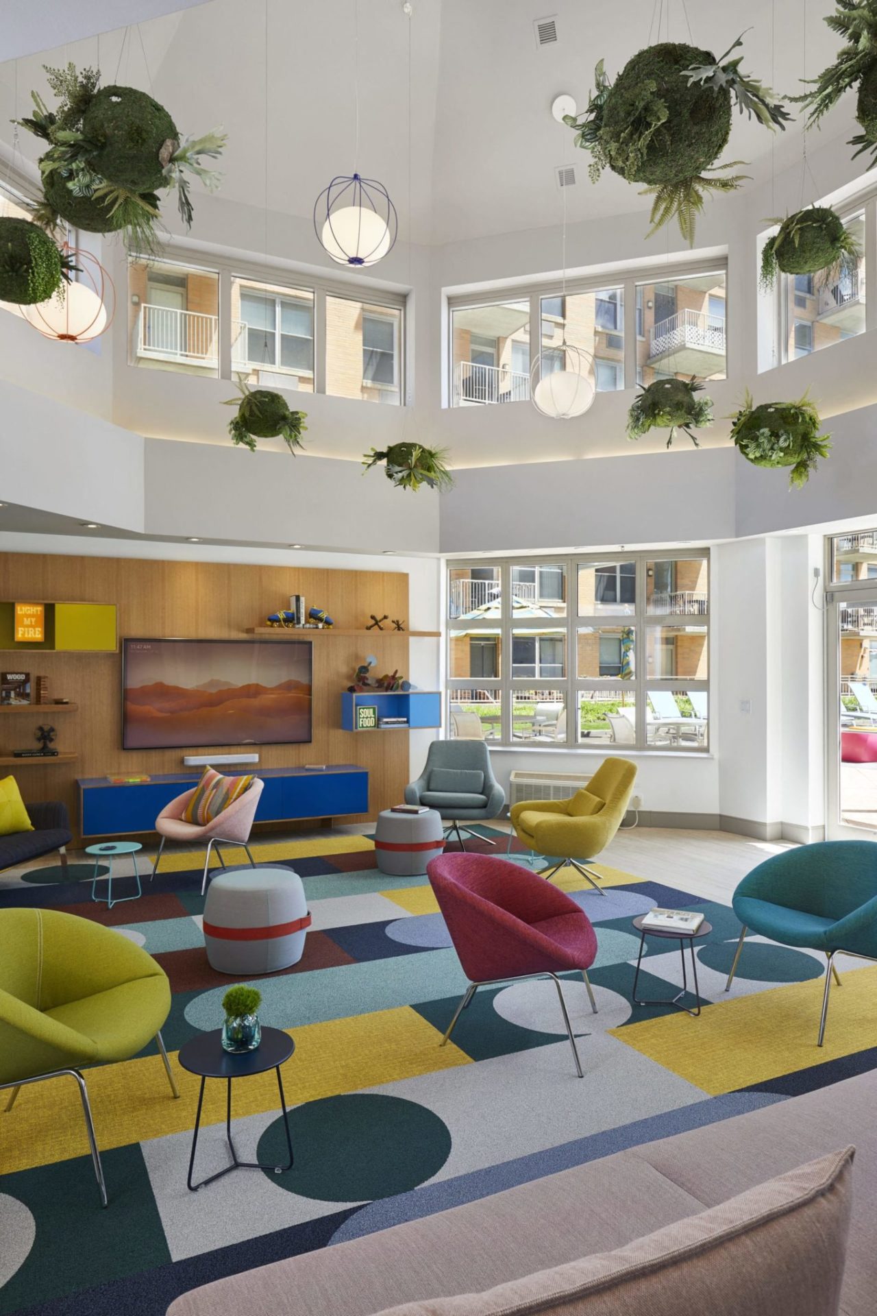 a living room with plants hanging from the ceiling