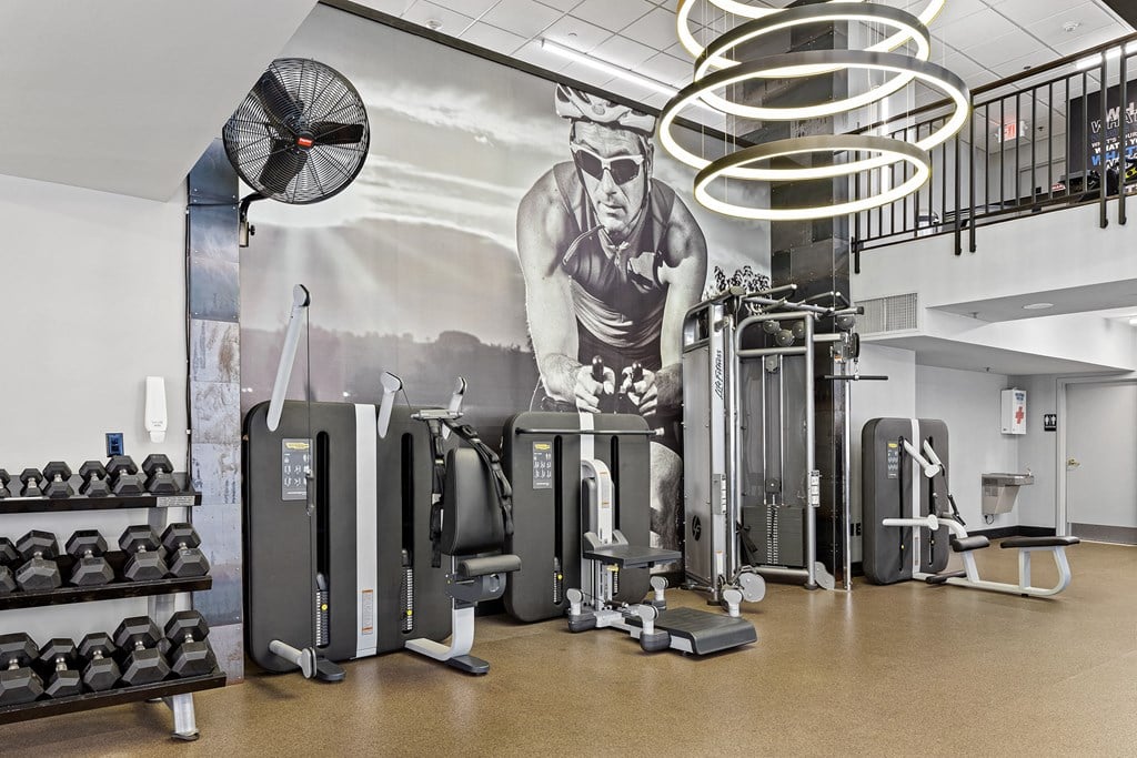 a wall mural of a man working out with weights in a gym