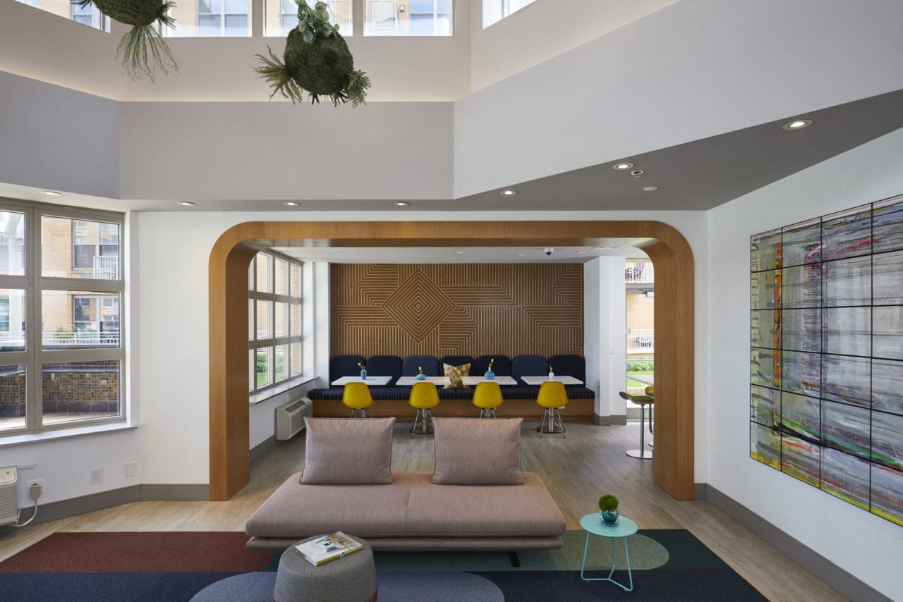 a living room with a couch and a table in the middle