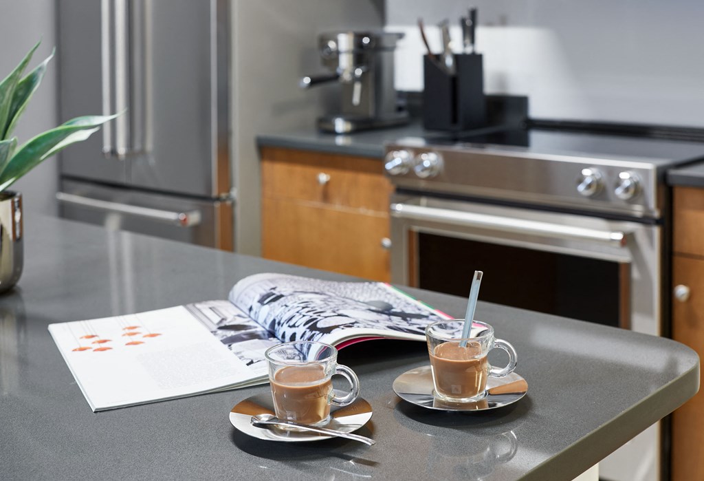 two cups of coffee sitting on a counter in a kitchen