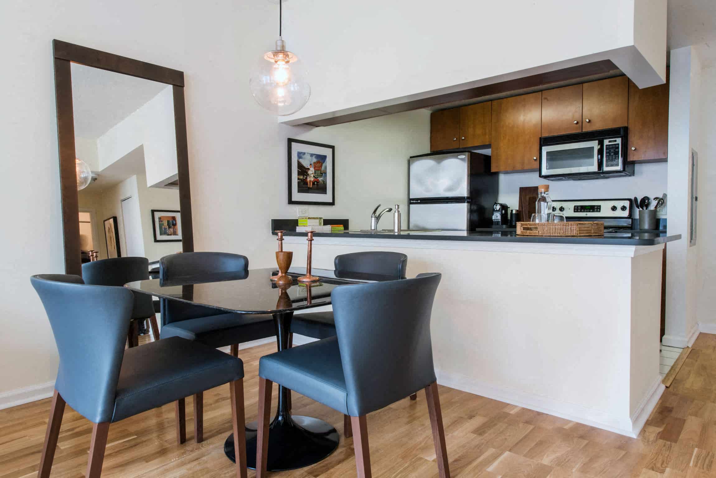 a dining room with a table and chairs and a kitchen