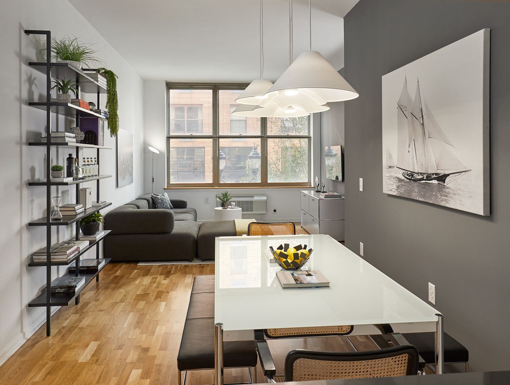 a living room and dining room with a white table and chairs