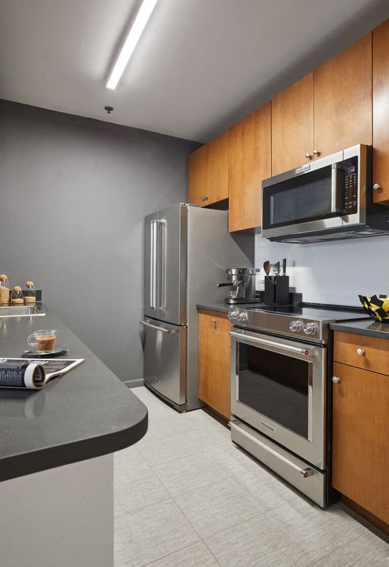 a kitchen with stainless steel appliances and a microwave