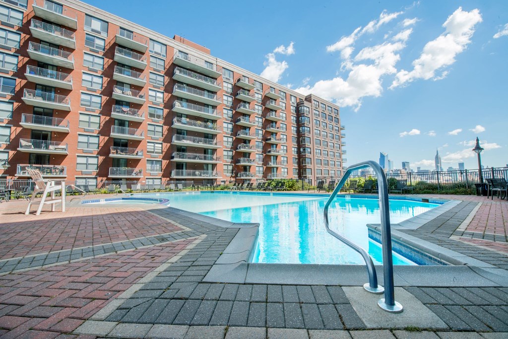 a swimming pool in front of an apartment building