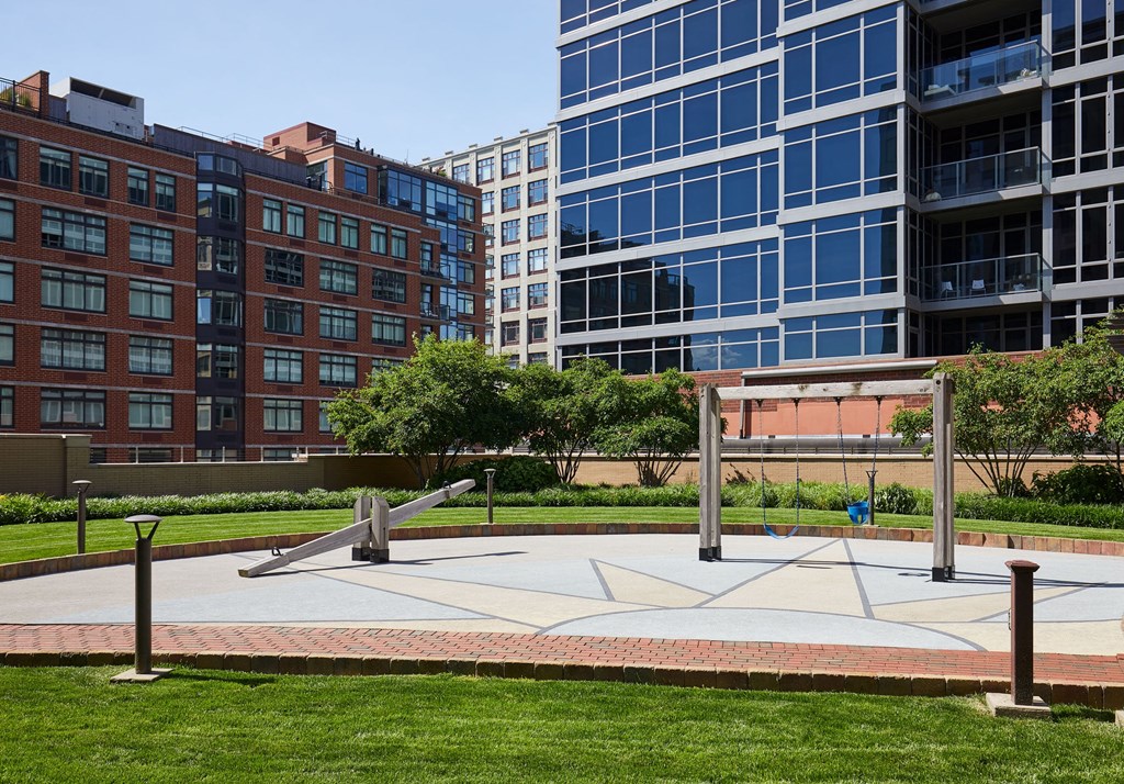 a park in front of some tall buildings