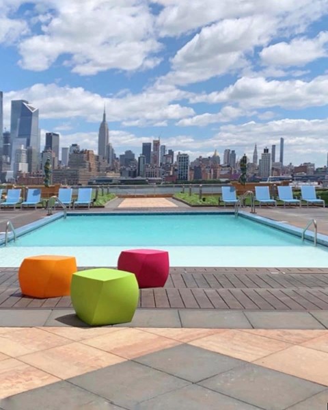 a pool with a city skyline in the background