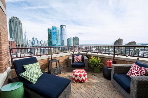 a balcony with furniture and a view of the city